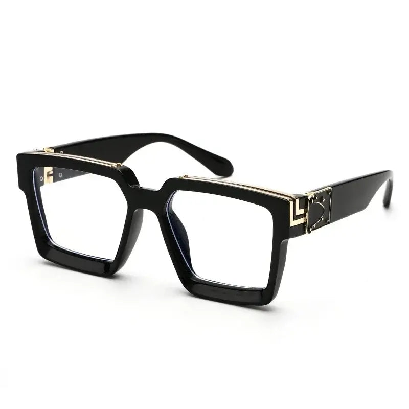 Black oversized square sunglasses with gold detail, trendy and fashionable eyewear for outdoor use.
