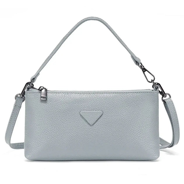 Shoulder bag in light gray leather, sleek design perfect for casual and formal occasions.