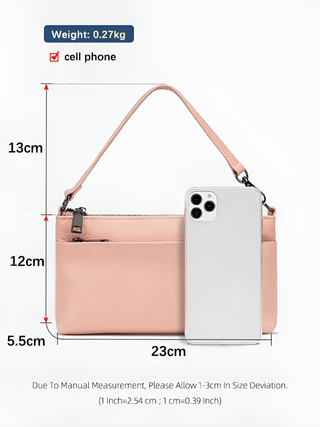 Shoulder bag leather black beside a cell phone, showcasing dimensions and lightweight design for versatility.