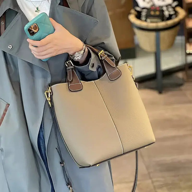 Solid beige leather shoulder bag with premium quality, perfect for stylish women on the go.