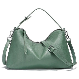 Green leather shoulder bag with adjustable strap, stylish design, and spacious interior for everyday essentials.