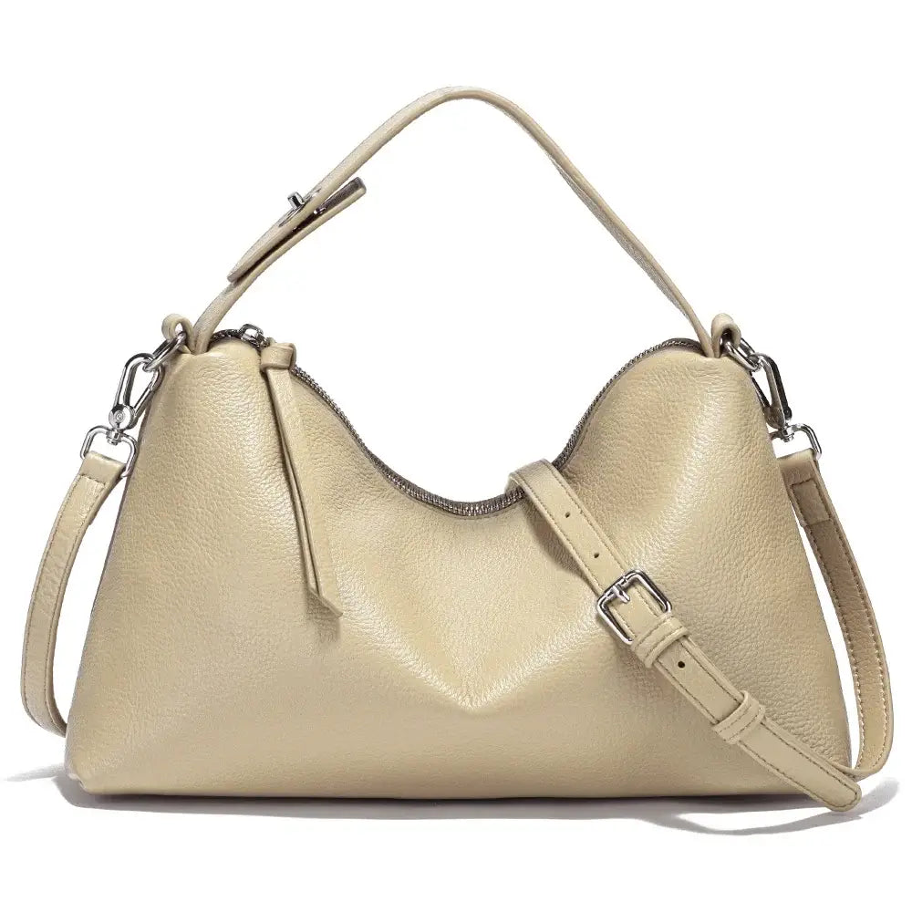 Relaxed beige hobo bag made from genuine leather, featuring a stylish design and adjustable strap for versatility.