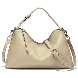 Relaxed beige hobo bag made from genuine leather, featuring a stylish design and adjustable strap for versatility.