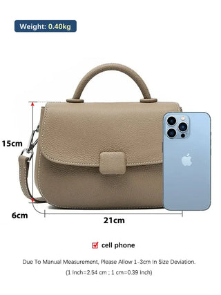 Soft leather shoulder bag in beige, featuring secure closure and spacious interior, ideal for everyday use.