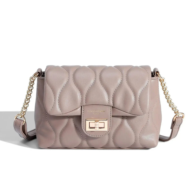 Women's quilted beige shoulder bag in soft taupe with chain strap and turn-lock closure, stylish and versatile for any occasion.