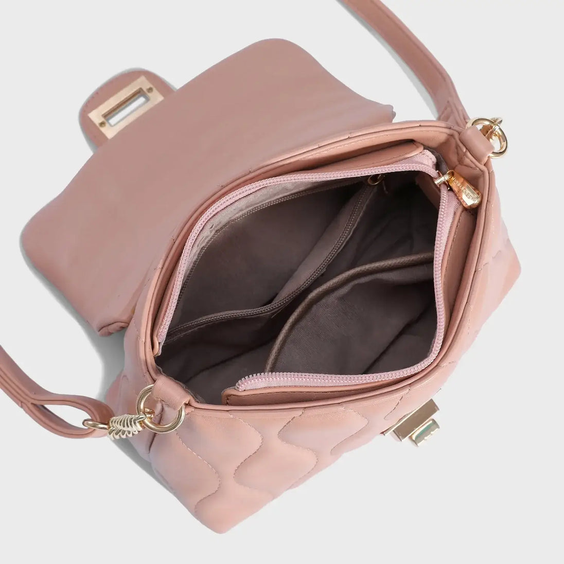 Women's pink quilted shoulder bag, interior view with pockets and chain strap, casual fashion style.