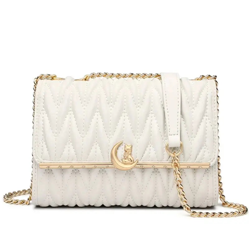 White quilted women’s shoulder bag with gold chain strap and moon cat charm for a stylish party accessory.