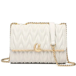 White quilted women’s shoulder bag with gold chain strap and moon cat charm for a stylish party accessory.