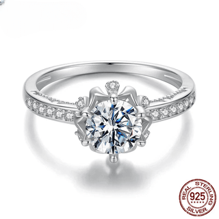Women's silver engagement ring with sparkling round cut moissanite crystal in prong setting.