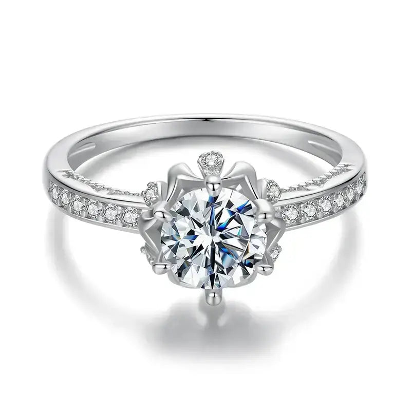 Women's silver wedding band featuring a sparkling round cut moissanite crystal with prong setting.