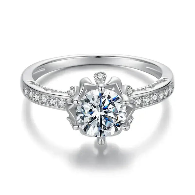 Women's silver wedding band featuring a sparkling round cut moissanite crystal with prong setting.