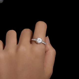 Women's silver engagement ring featuring a sparkling round cut crystal, showcasing a classic style and prong setting.