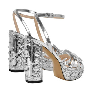 High-quality handmade silver patent leather platform sandals with decorative details and secure ankle strap.