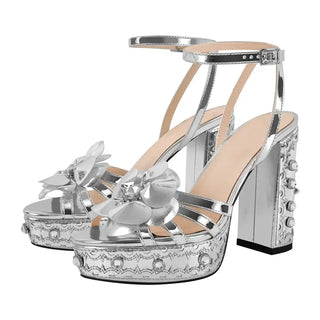 High-quality silver platform sandals with floral accent and chunky heel, combining style and comfort for any occasion.