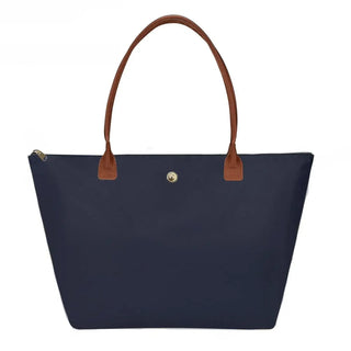 Green women’s tote bag with brown handles and zipper closure, stylish and spacious for special occasions.