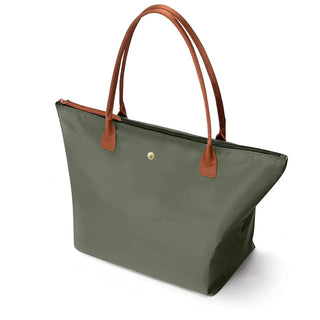 Green women’s tote bag with brown handles, zipper closure, stylish for parties, durable TPU material, elegant design.