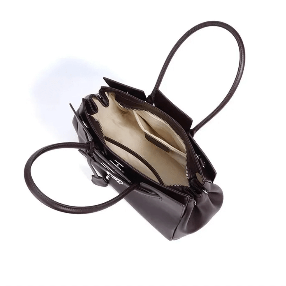 Dark brown leather women’s tote bag with top handles, open showcasing spacious interior and silver lock detail.