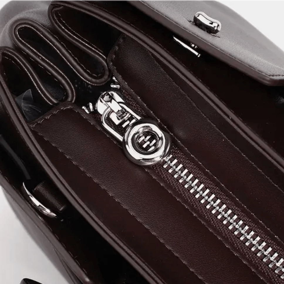Interior view of dark brown leather women's tote bag showing zipper and compartments for organized storage.