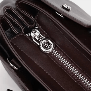 Interior view of dark brown leather women's tote bag showing zipper and compartments for organized storage.