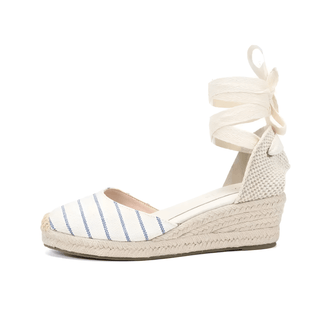 Women's espadrille sandals in white and navy stripes with lace-up ankle straps for stylish summer wear.