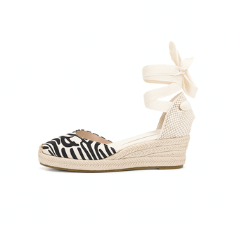 Espadrille sandals in black and white zebra print with lace-up ankle straps for women's casual style.