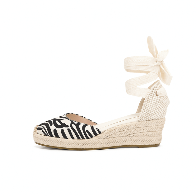 Espadrille sandals in black and white zebra print with lace-up ankle straps for women's casual style.
