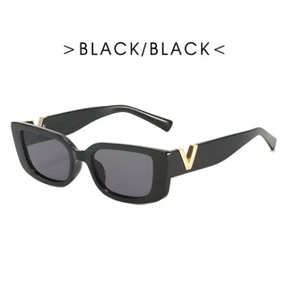 Women’s sunglasses in black, trendy rectangular style with UV400 protection.