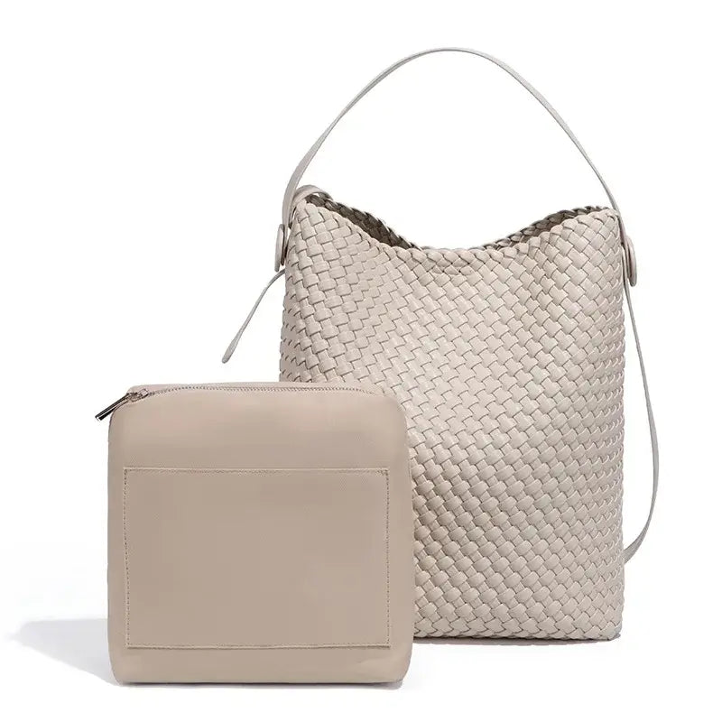 Woven leather bucket shoulder bag in beige with matching zippered pouch for stylish and functional everyday use.