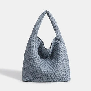 Woven shoulder bag in light blue, handmade tote for women, ideal for casual use, featuring a stylish criss-cross design.