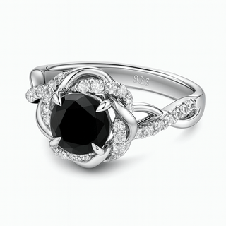 Silver ring with a black gemstone and diamond accents on a white background