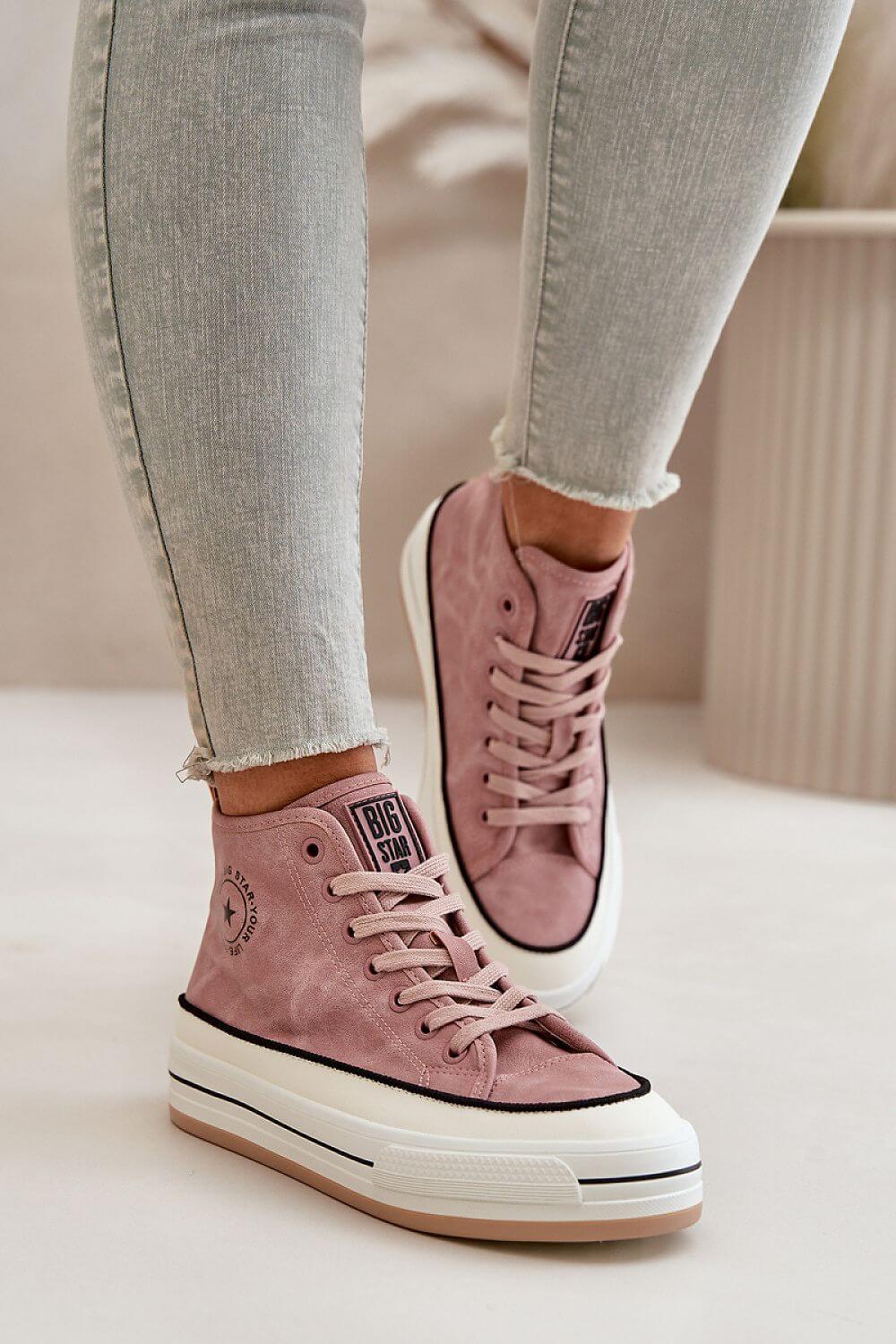 Women's sneakers in pink from Big Star worn with light blue jeans, showcasing comfort and style.