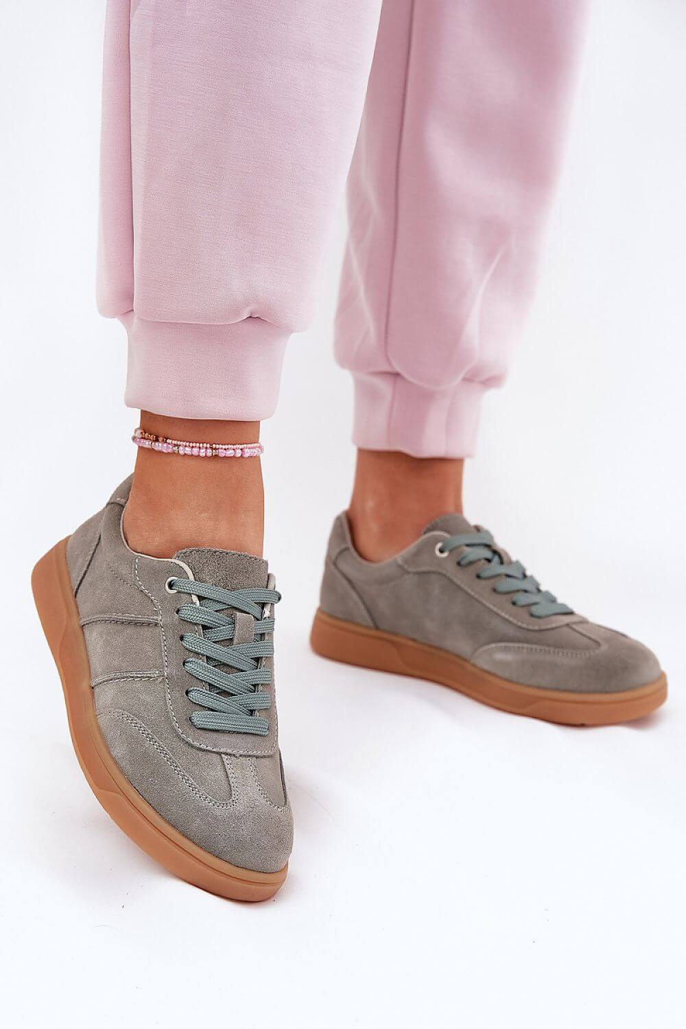 Sport shoes in gray suede with rounded toes and classic lacing, perfect for casual styling.