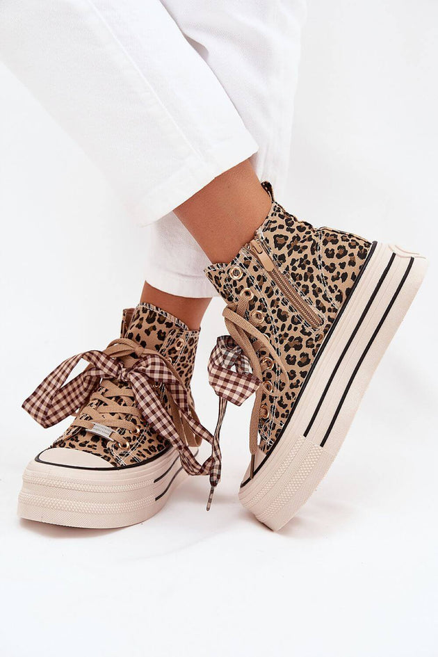 Women's sneakers made of textile material with leopard print and ribbon decoration, featuring a platform sole.