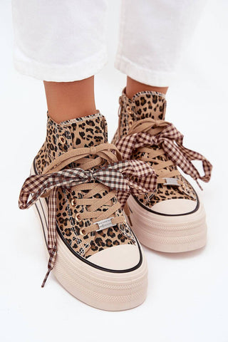 Women's sneakers with leopard print design, textile material, platform sole, and stylish ribbon laces.