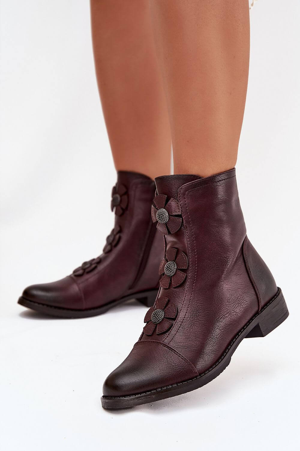 Women's boots by Jezzi featuring decorative flowers and a comfortable flat heel, perfect for everyday wear.