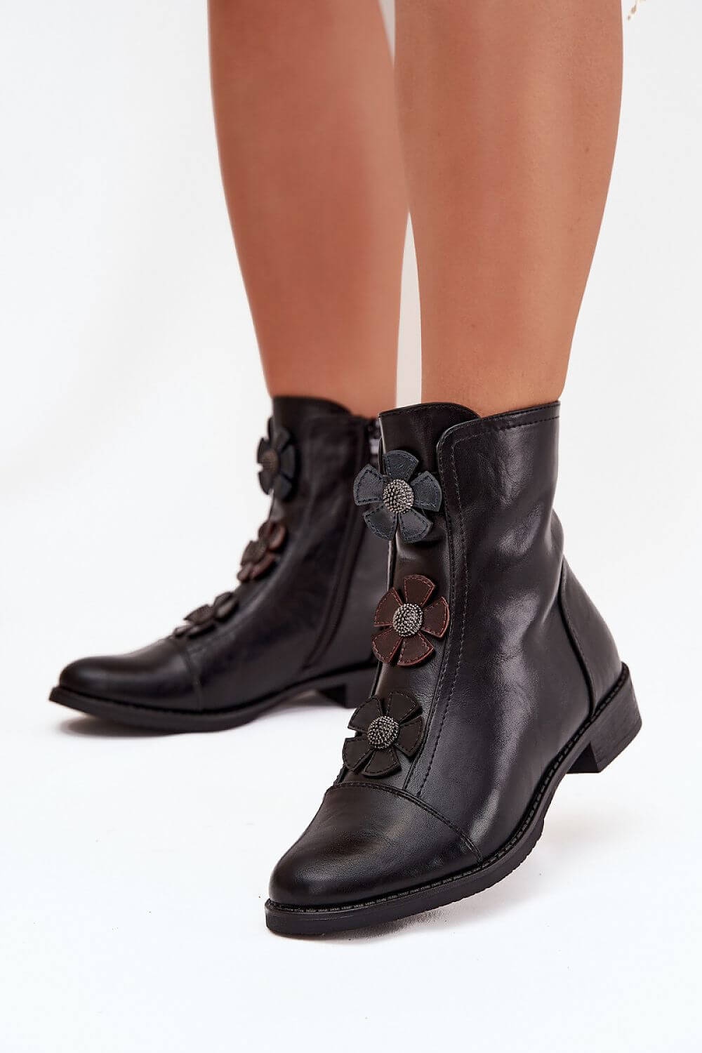Women's boots by Jezzi featuring decorative flowers and a stylish zipper for easy wear.
