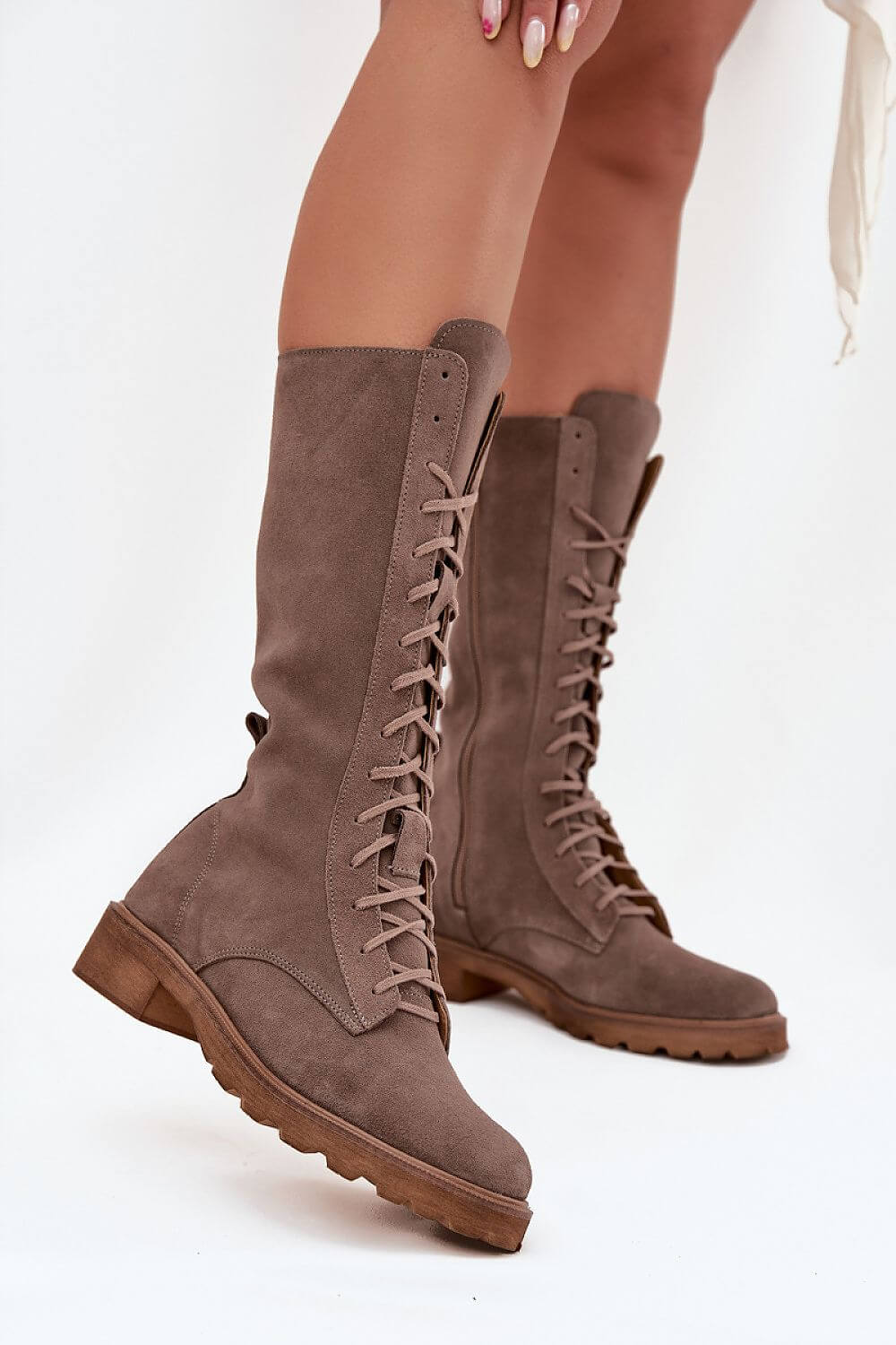 Women's ankle boots made of natural suede with lacing and a mid-calf design for elegant style.