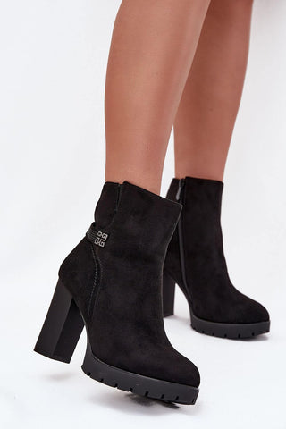 Women's ankle boots made of eco suede with a pedestal heel and decorative strap, perfect for colder days.