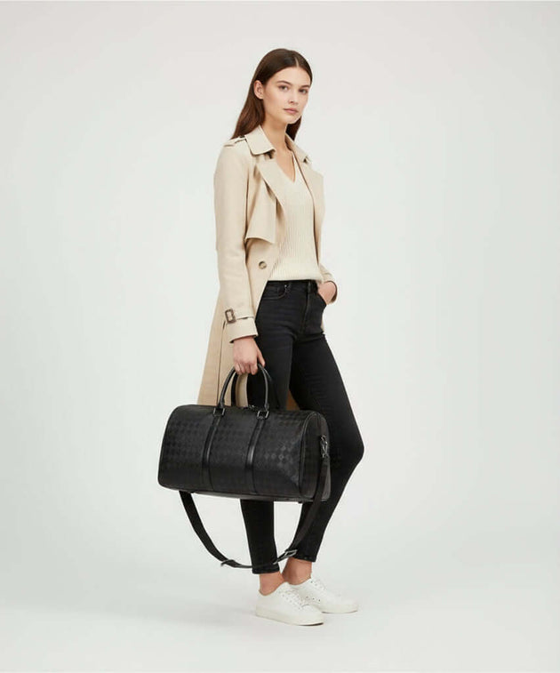 Model wearing a trench coat with a Travel Duffle Bag, showcasing its stylish design and practicality for travel.