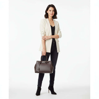Womens Leather Tote Bag displayed by a model in stylish outfit, showcasing its upscale design and elegance.