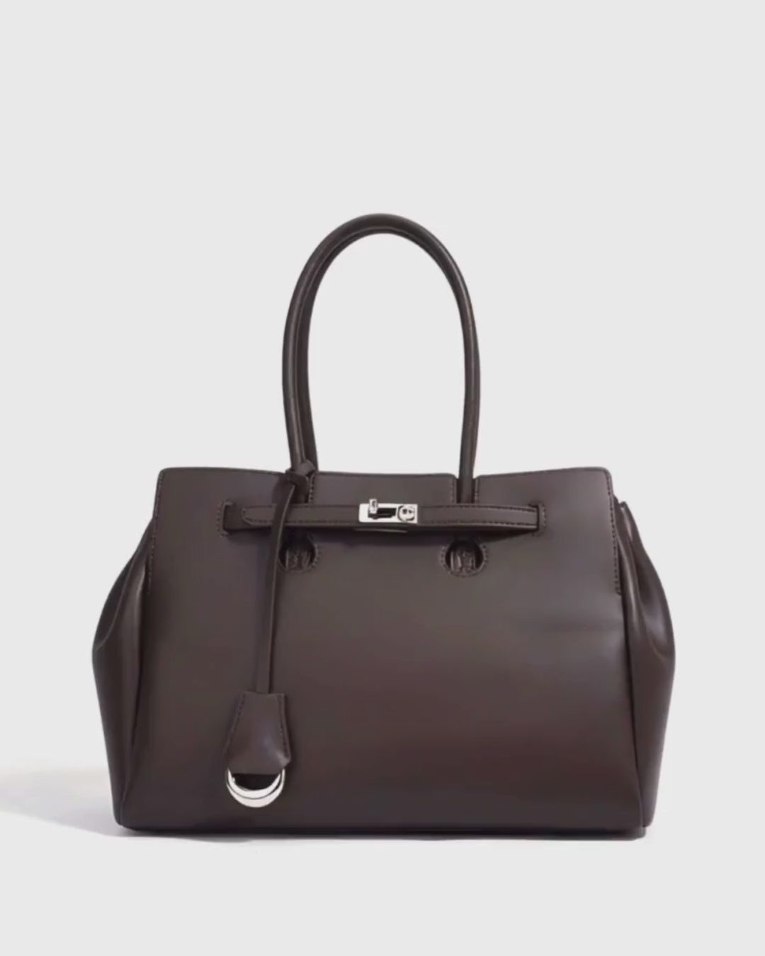 Womens Leather Tote Bag in dark brown with silver lock detail for elegant and durable everyday use.